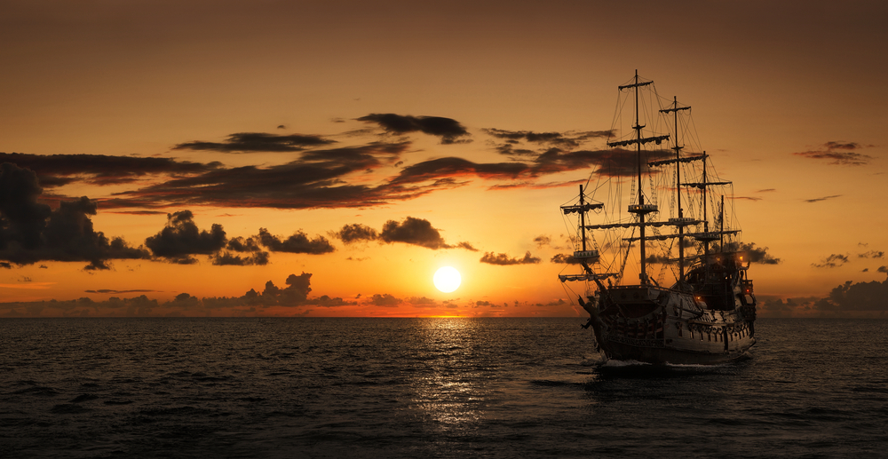 Pirate Ship at Sea with Sunset